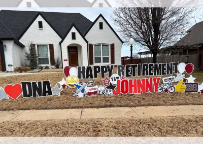 Happy retirement yard sign with colorful letters, celebrating a person's transition to retirement.